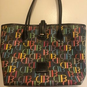 Dooney & Bourke medium tote. Used , good condition. Inside red, zipper pocket